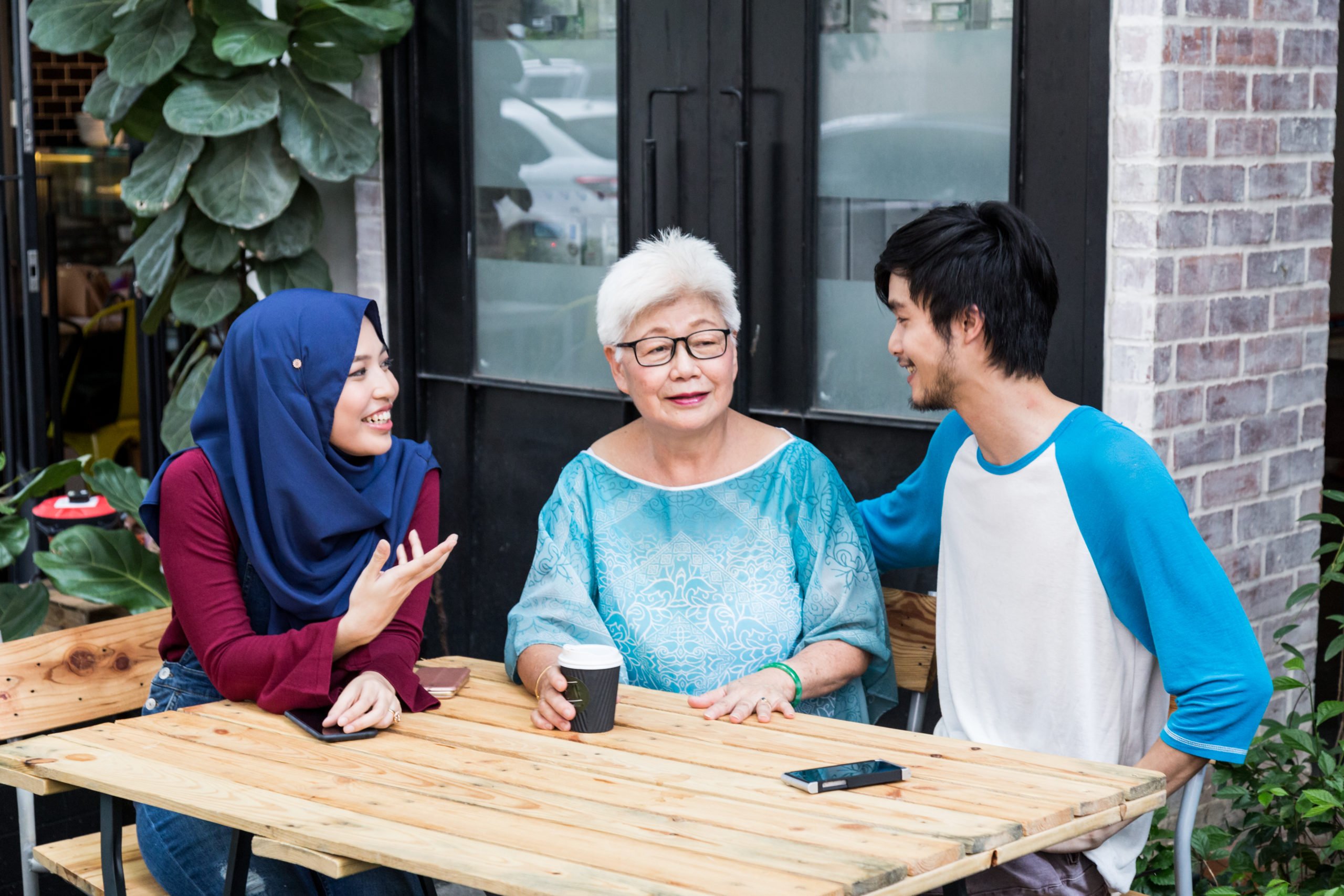 Series of young Malay couple with elderly women having conversation over coffee